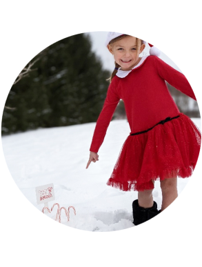 Child pointing at Candy Cane garden growing in snow
